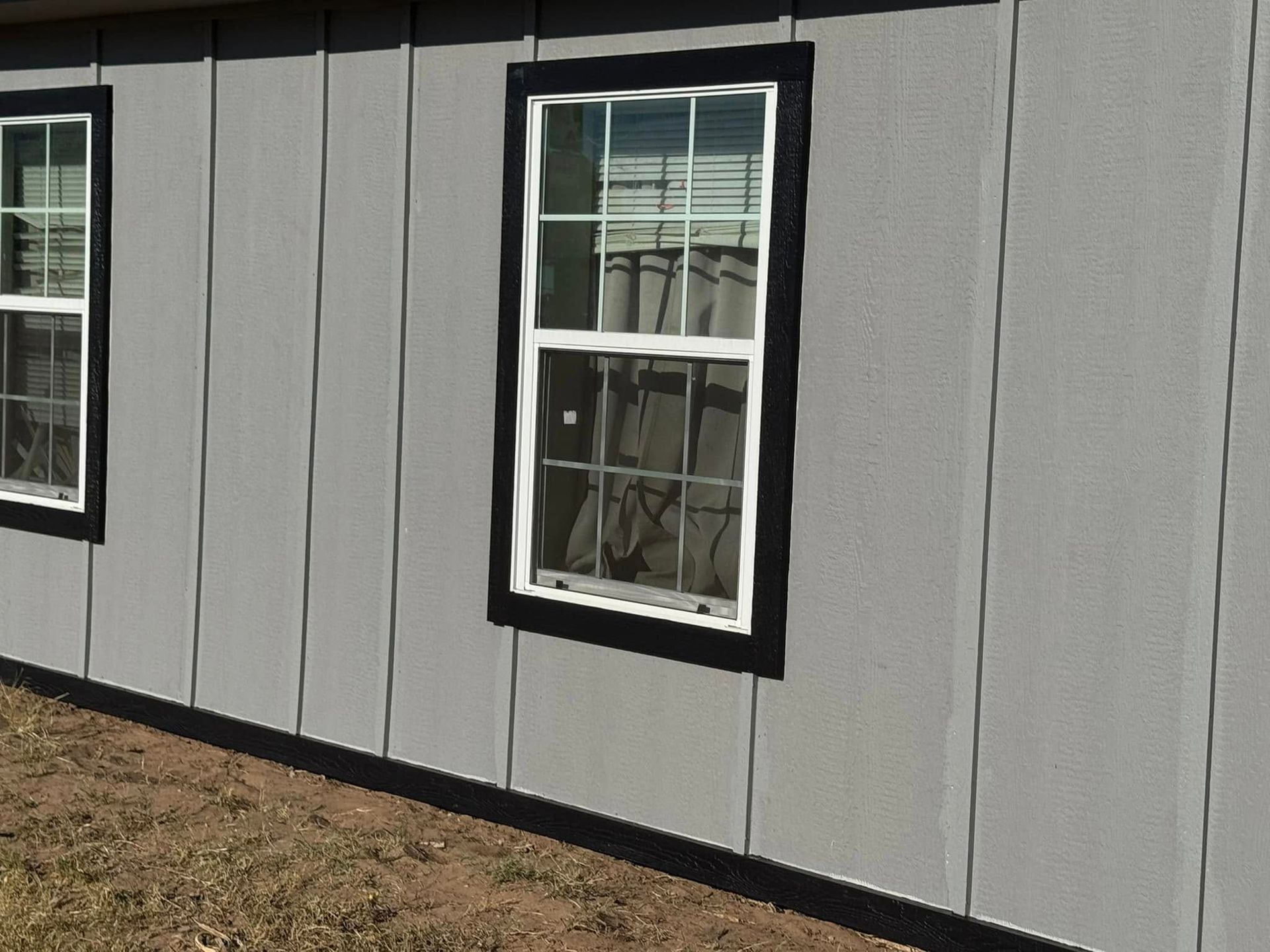 A house with two windows on the side of it