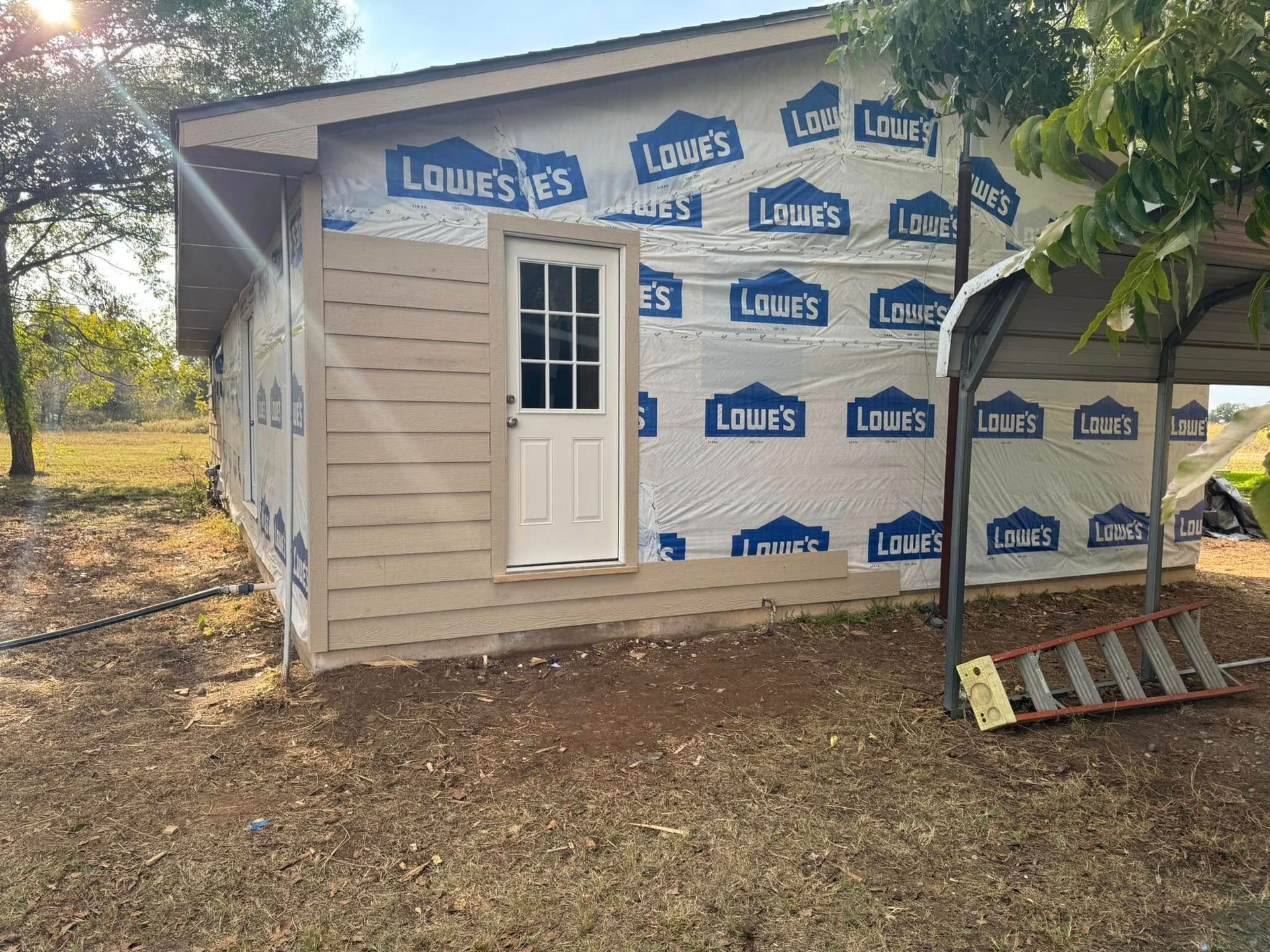 A small house with a ladder in front of it is being built.