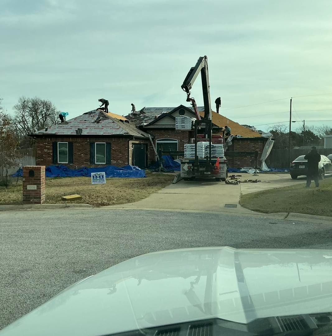 A white car is parked in front of a house that is being remodeled.