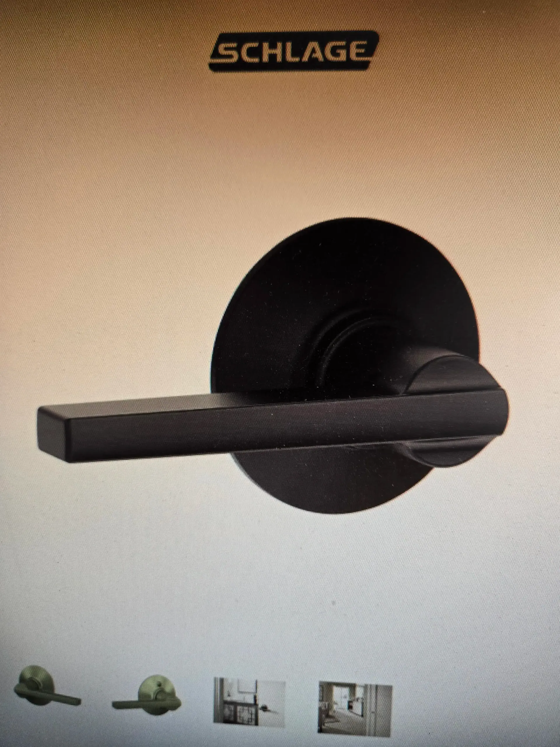 Black Schlage door handle on a beige door, close-up.