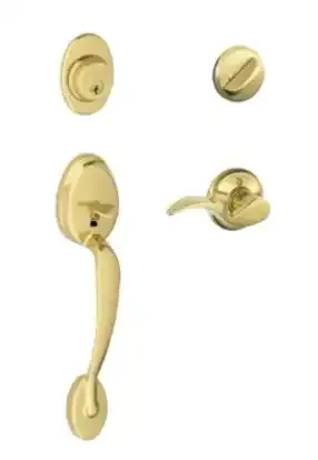 Gold door handle set with matching round knob and lock components on white background