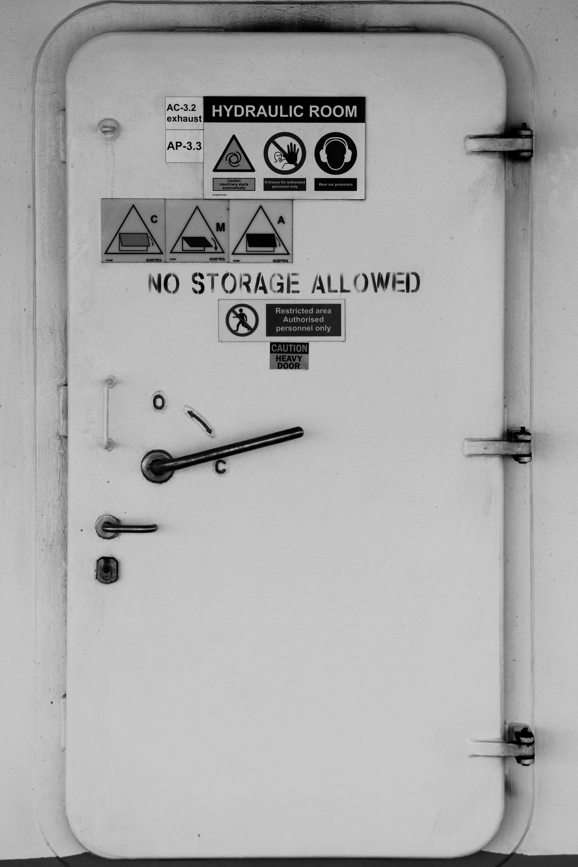 Keys in a lock on a green front door.