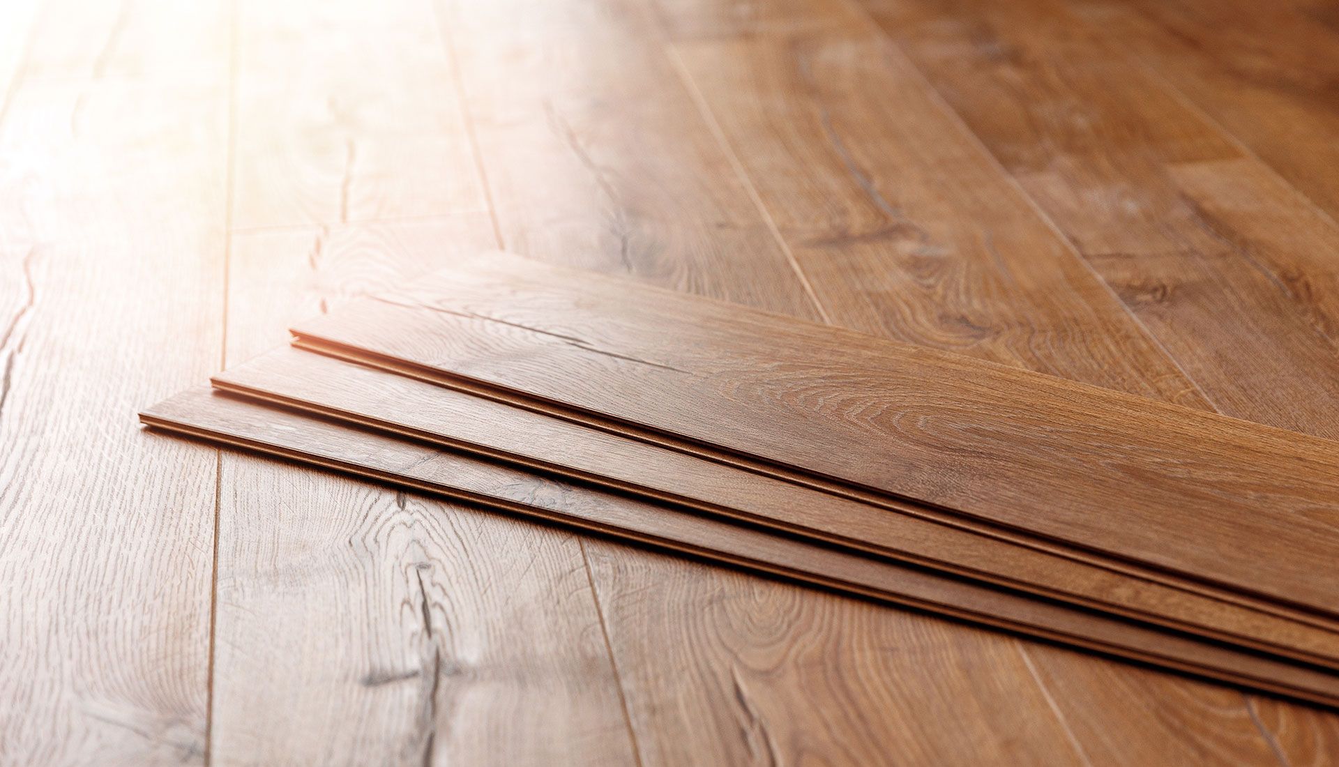 Three pieces of wood are stacked on top of each other on a wooden floor.