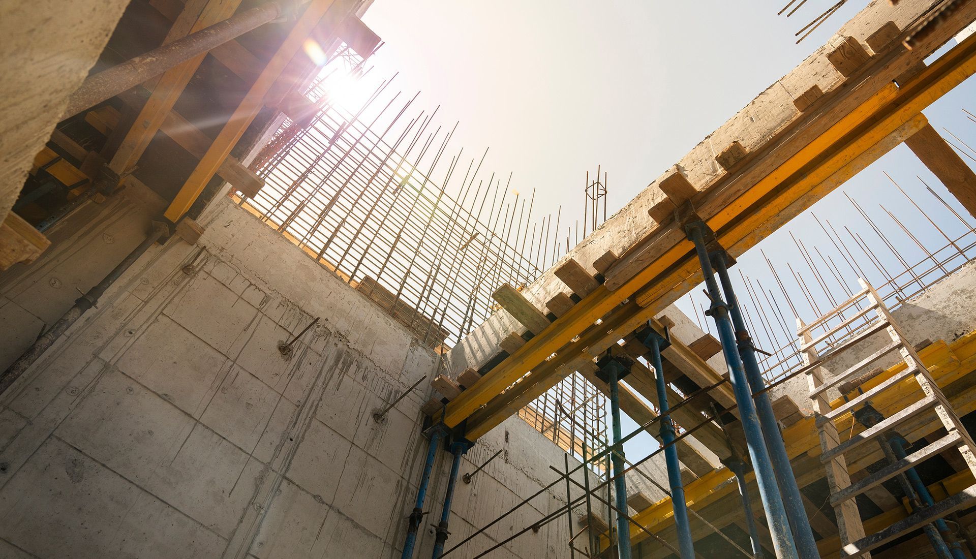 The sun is shining through the ceiling of a building under construction.