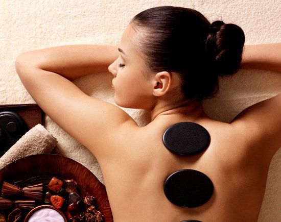 Woman Having Stone Massage — Greensburg, PA — Allanté Hair Design and Spa