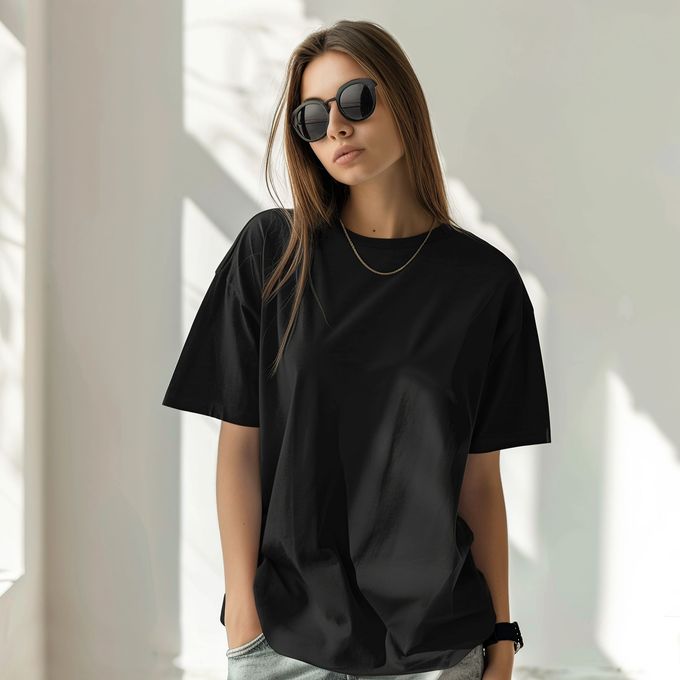 A woman wearing sunglasses and a black t-shirt
