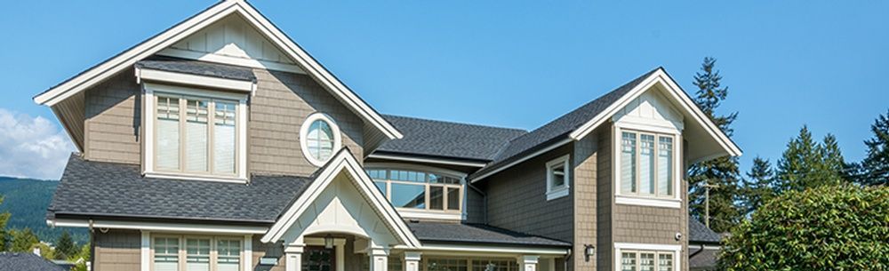 a large house with a lot of windows on a sunny day