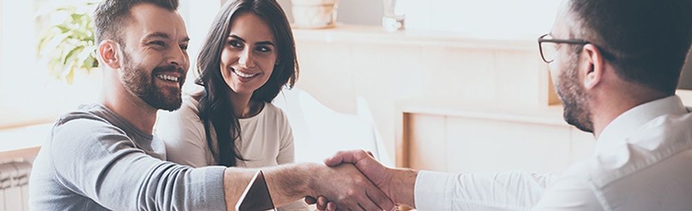 a man and a woman are shaking hands with a man