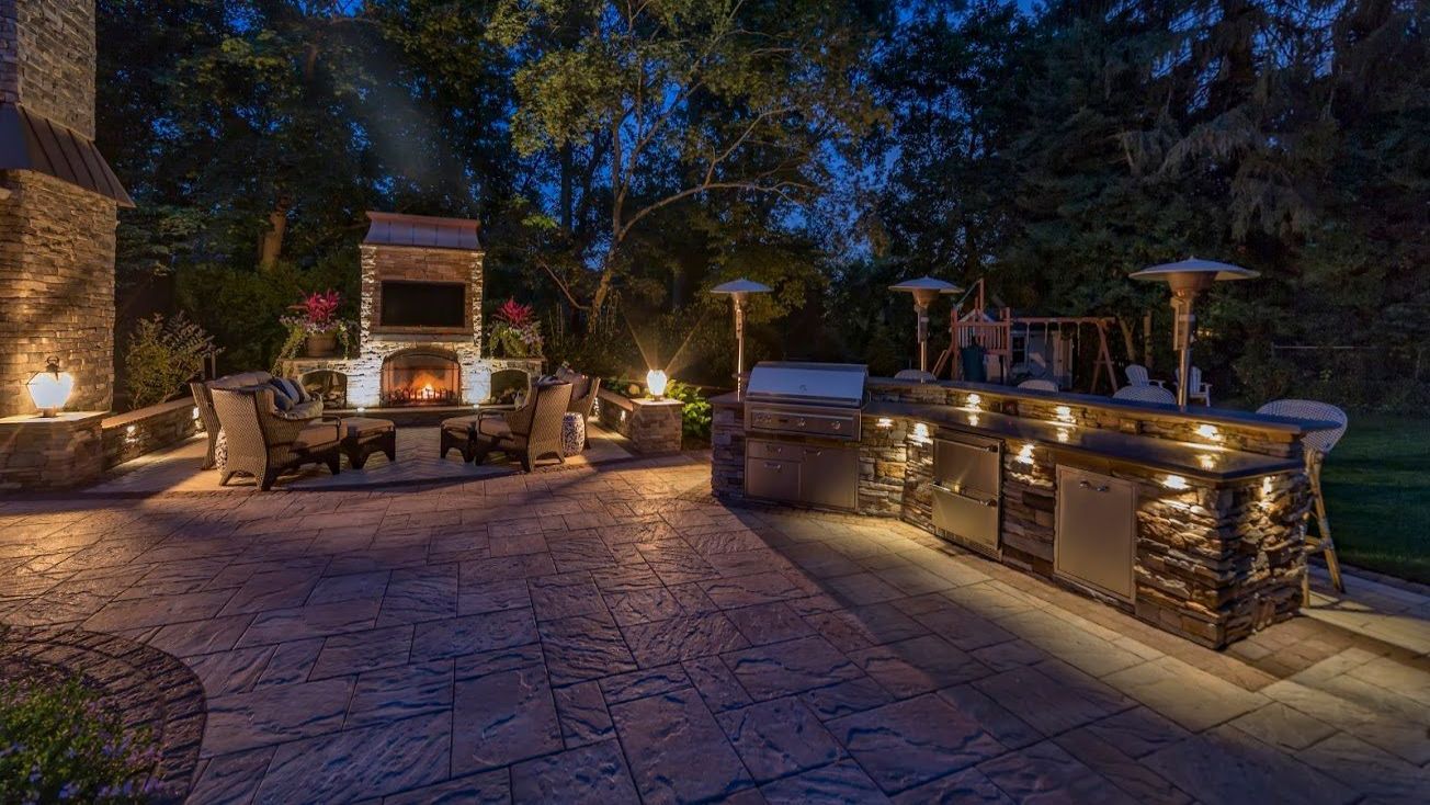 Backyard patio with professionally installed landscape lighting in South Carolina