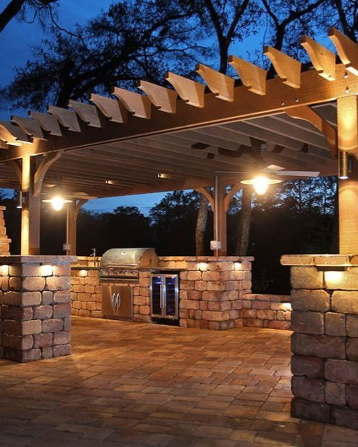 A beige Generac standby generator positioned outdoors in front of blue siding and a small window.