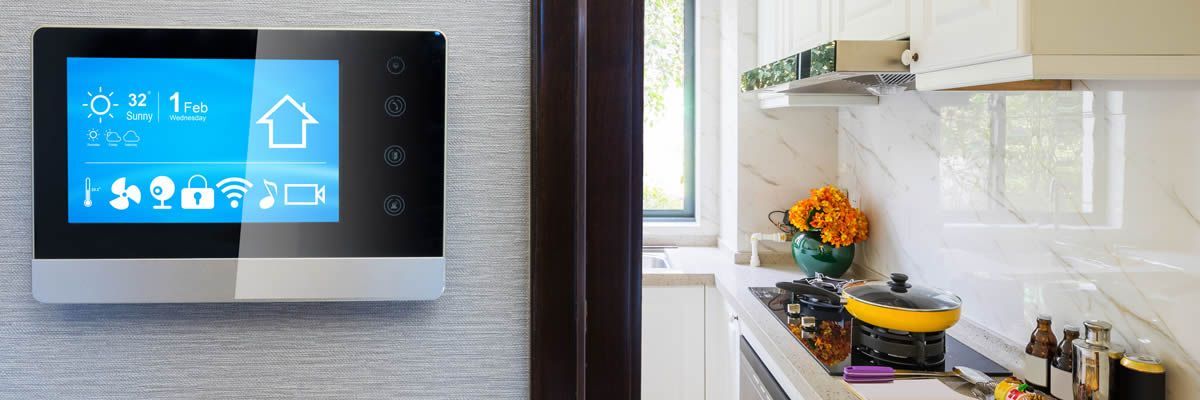 Smart home control panel on a wall in a modern kitchen. Panel displays home settings.