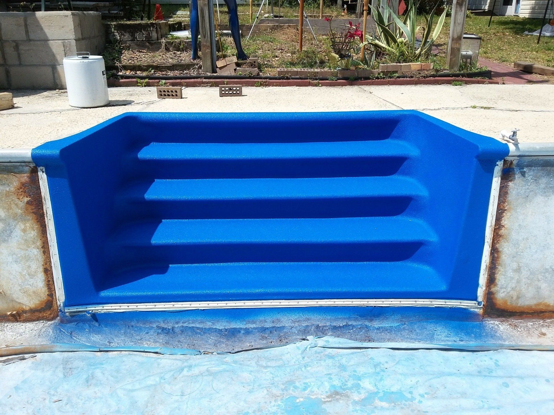 A blue staircase leading to a swimming pool