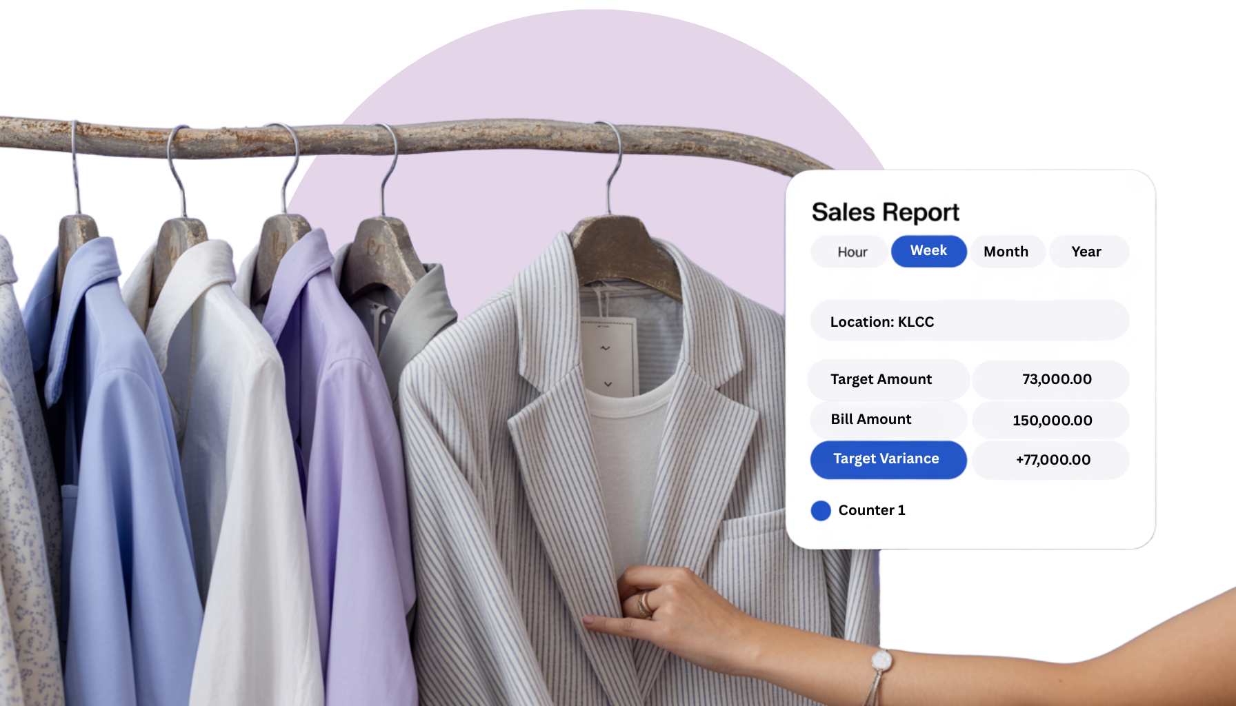 A woman is holding a jacket in front of a rack of clothes.