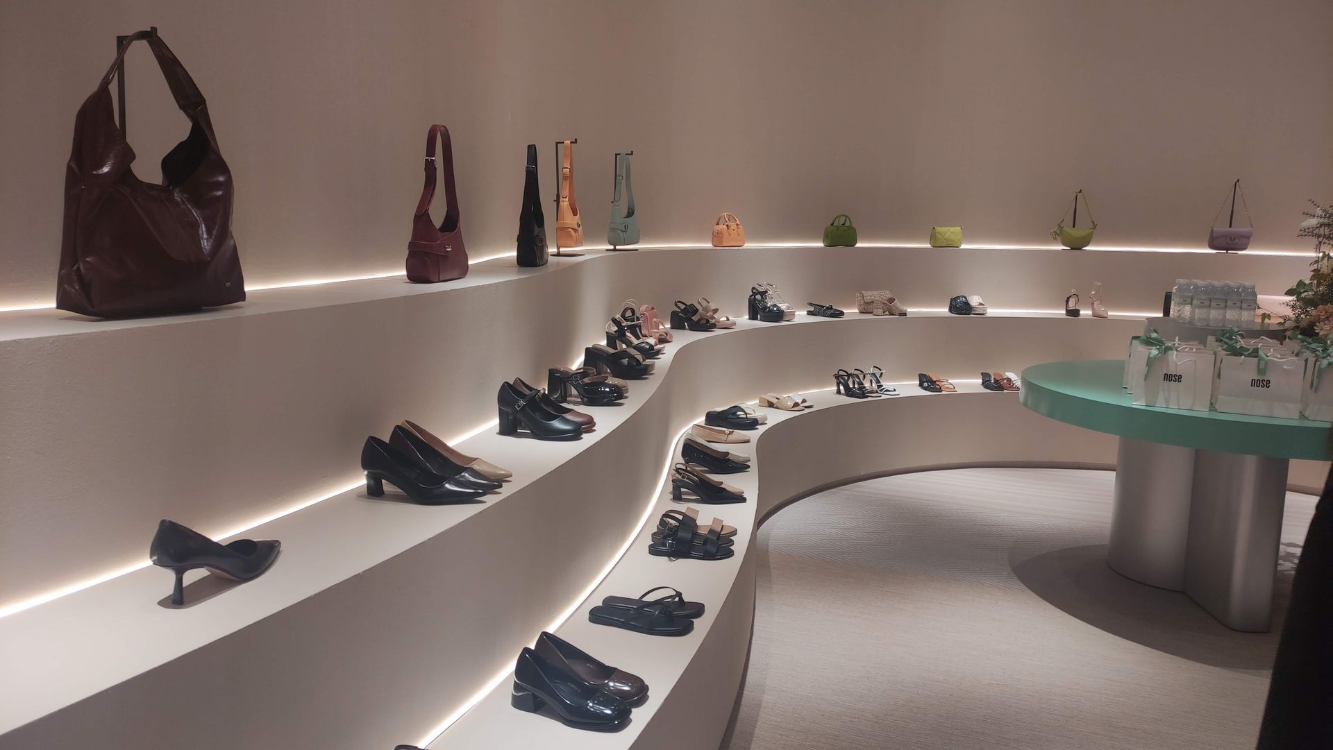 A display of shoes and handbags in a store