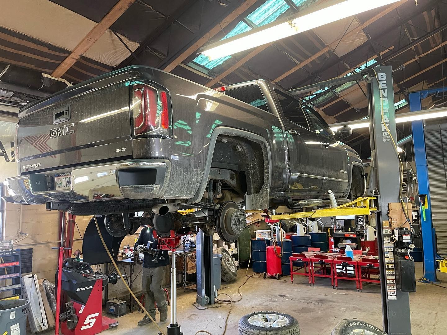 GMC Pickup Truck Raised on Lift for Brake or Suspension Work | Abbott Automotive & Tire