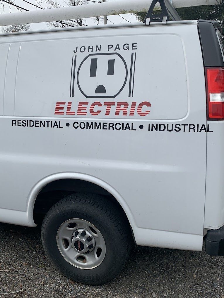 A white van that says john page electric residential commercial industrial