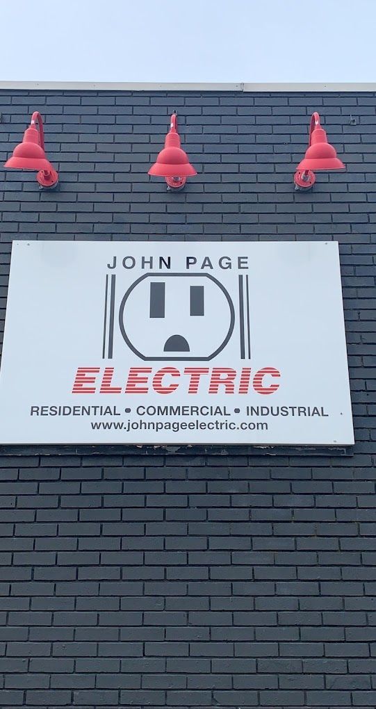 A sign on the side of a building that says john page electric