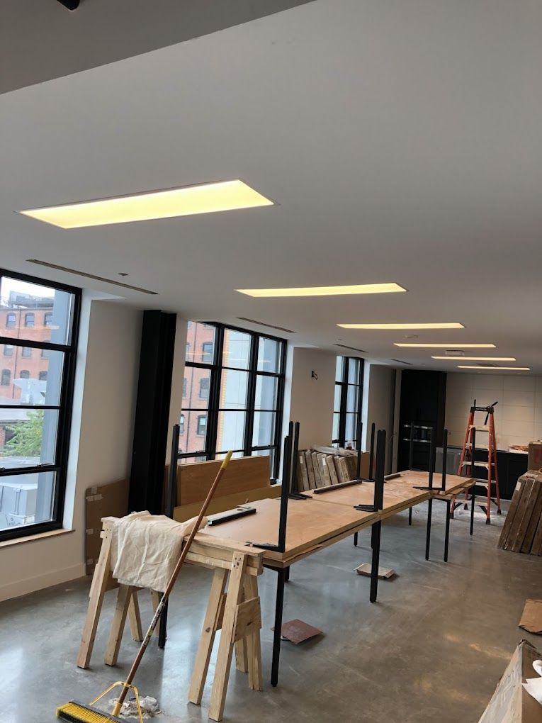 A large room with tables and a mop in it