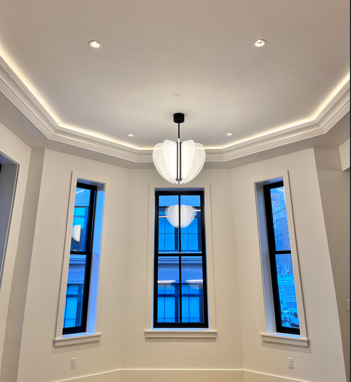 A room with a chandelier hanging from the ceiling