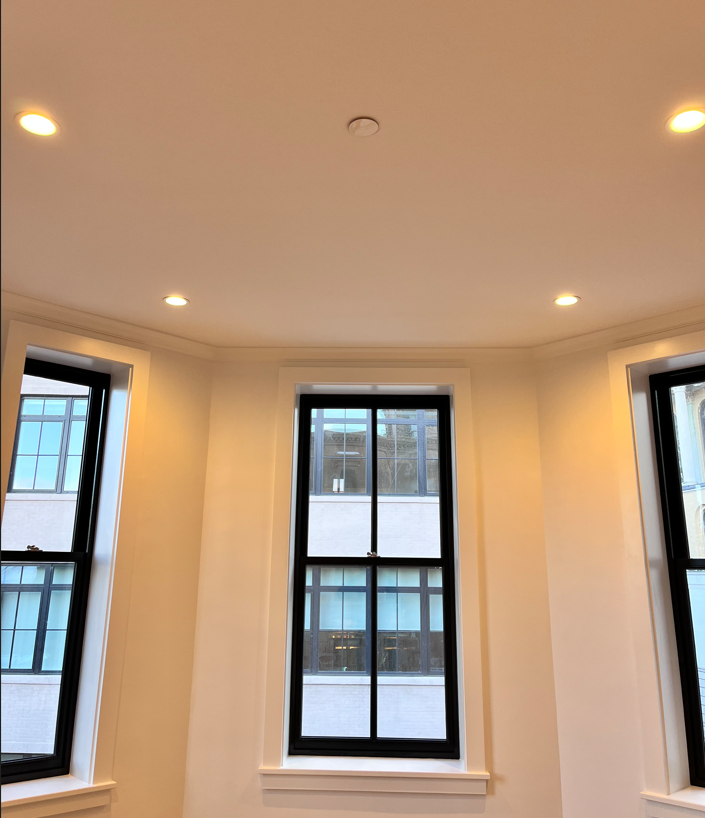 A room with two windows and a ceiling that has the letter h on it