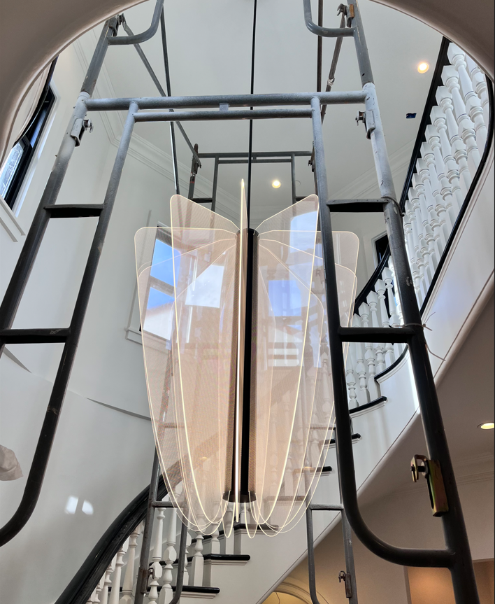 A staircase with a light hanging from the ceiling