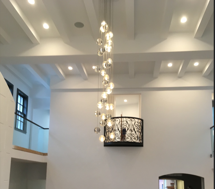 A large chandelier is hanging from the ceiling of a room