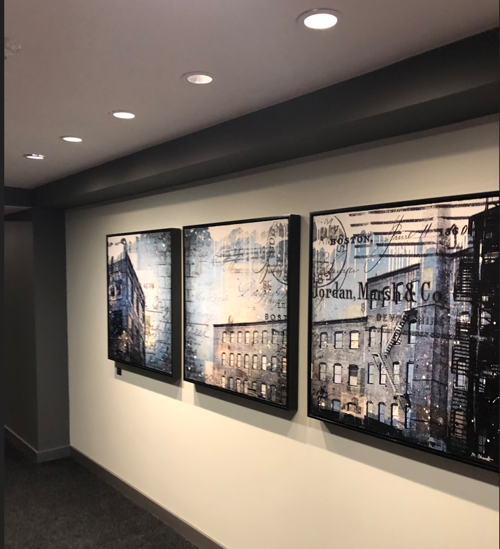 Three framed pictures on a wall one of which says ' jordan ' on it