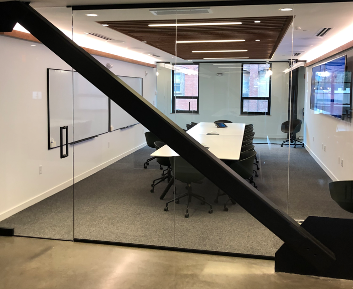 A conference room with a table and chairs in it