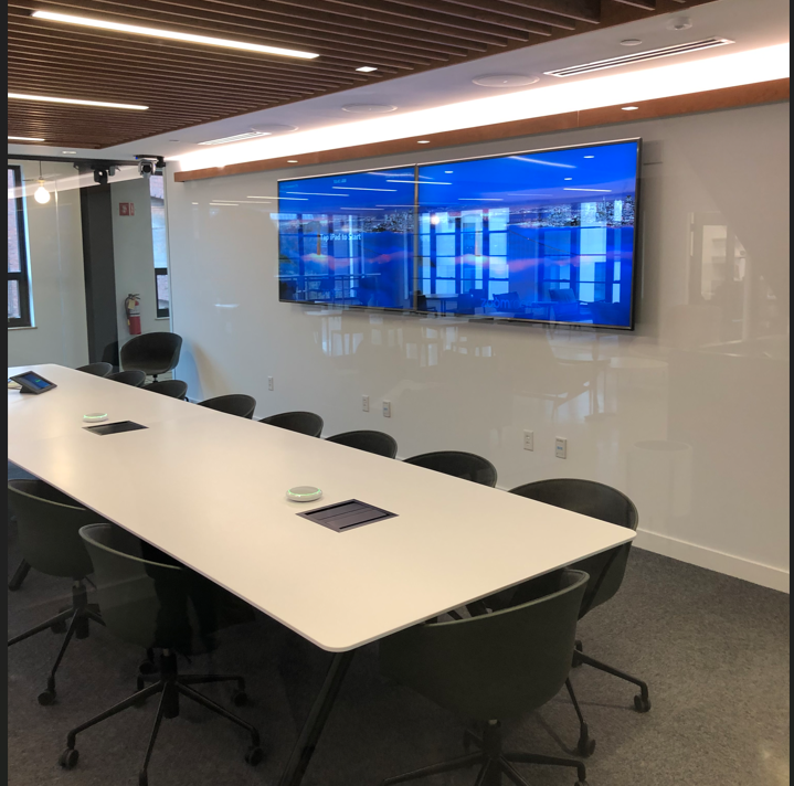 A conference room with a long table and chairs