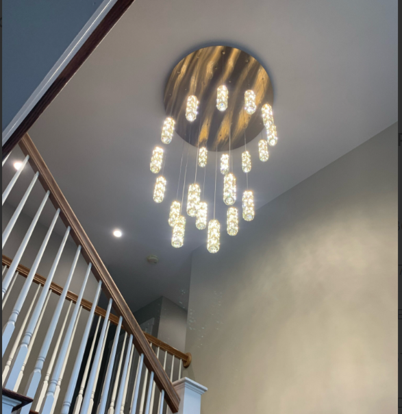 A staircase with a chandelier hanging from the ceiling