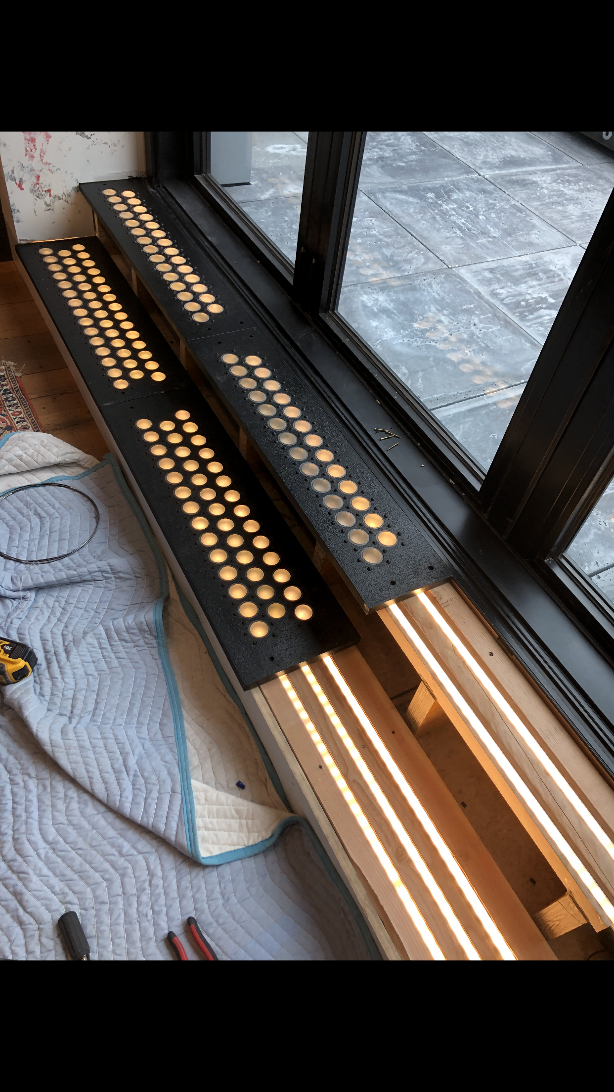 A radiator is sitting under a window in a room.