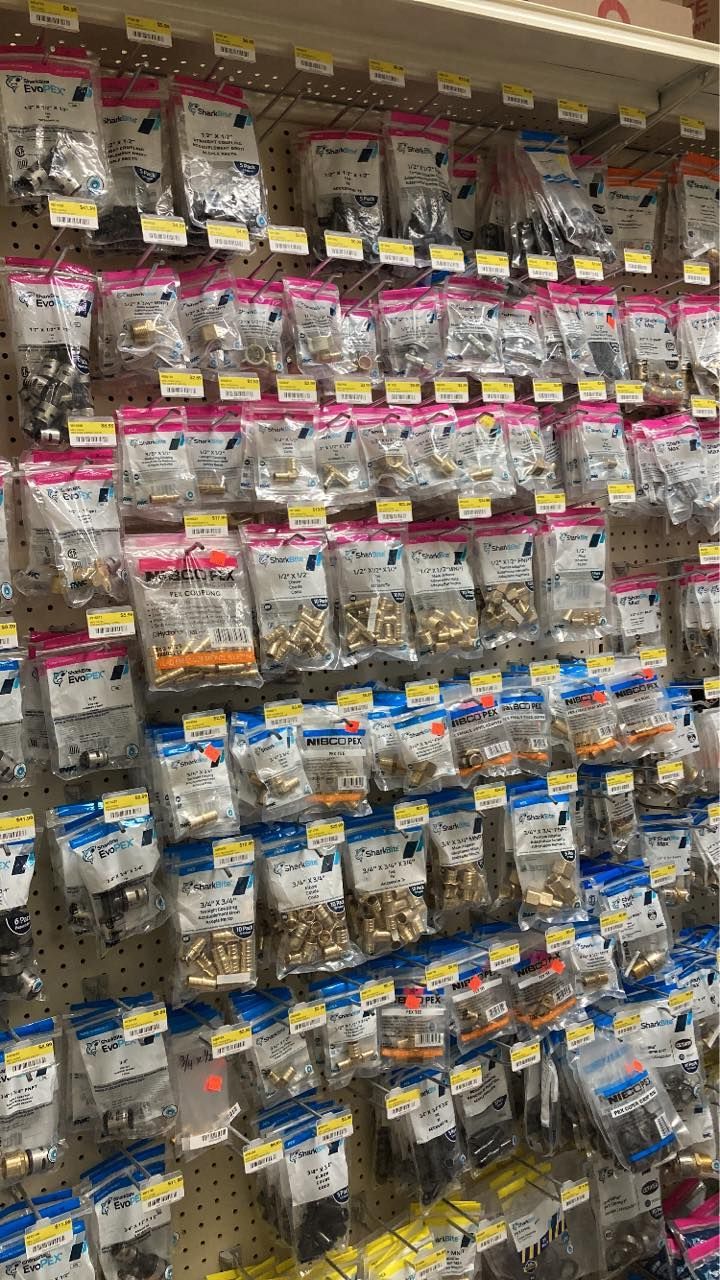 Hardware store display of bagged metal fittings.