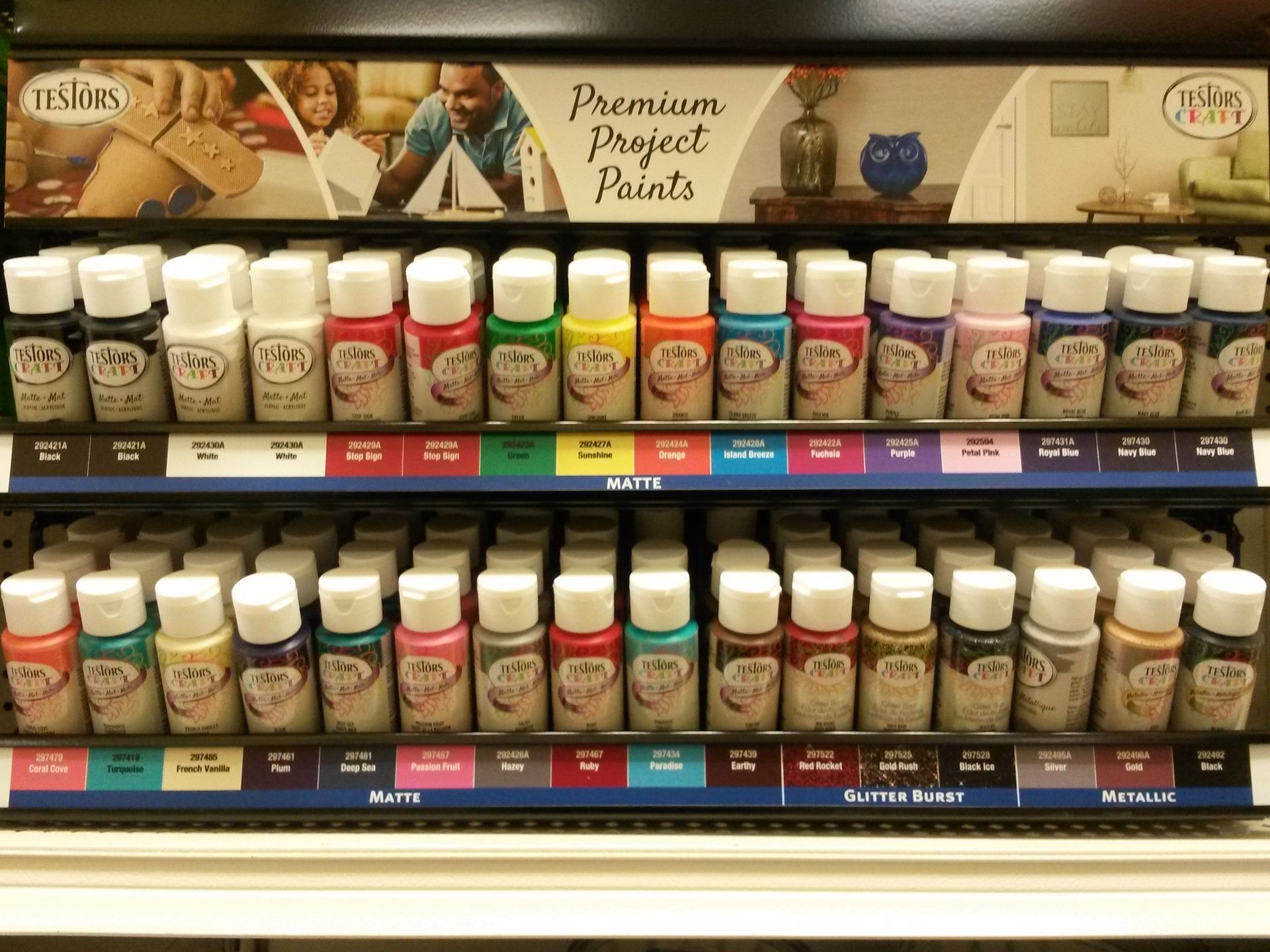 Rows of craft paint bottles in various colors on display.