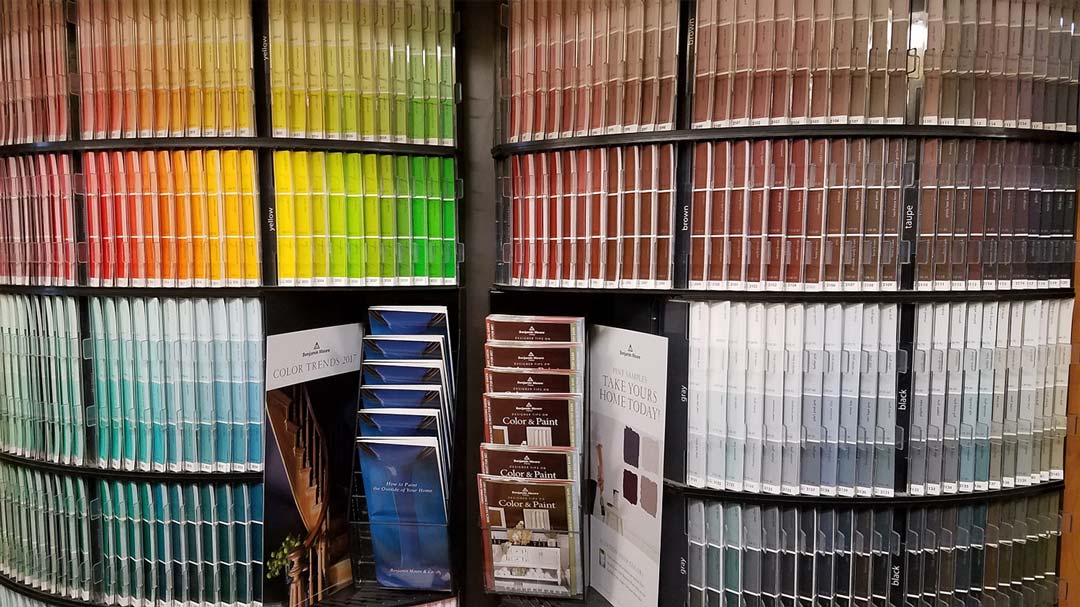Paint color swatches in various hues displayed on shelves.