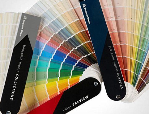 Color swatches from Benjamin Moore, fanned out, showcasing various paint colors.