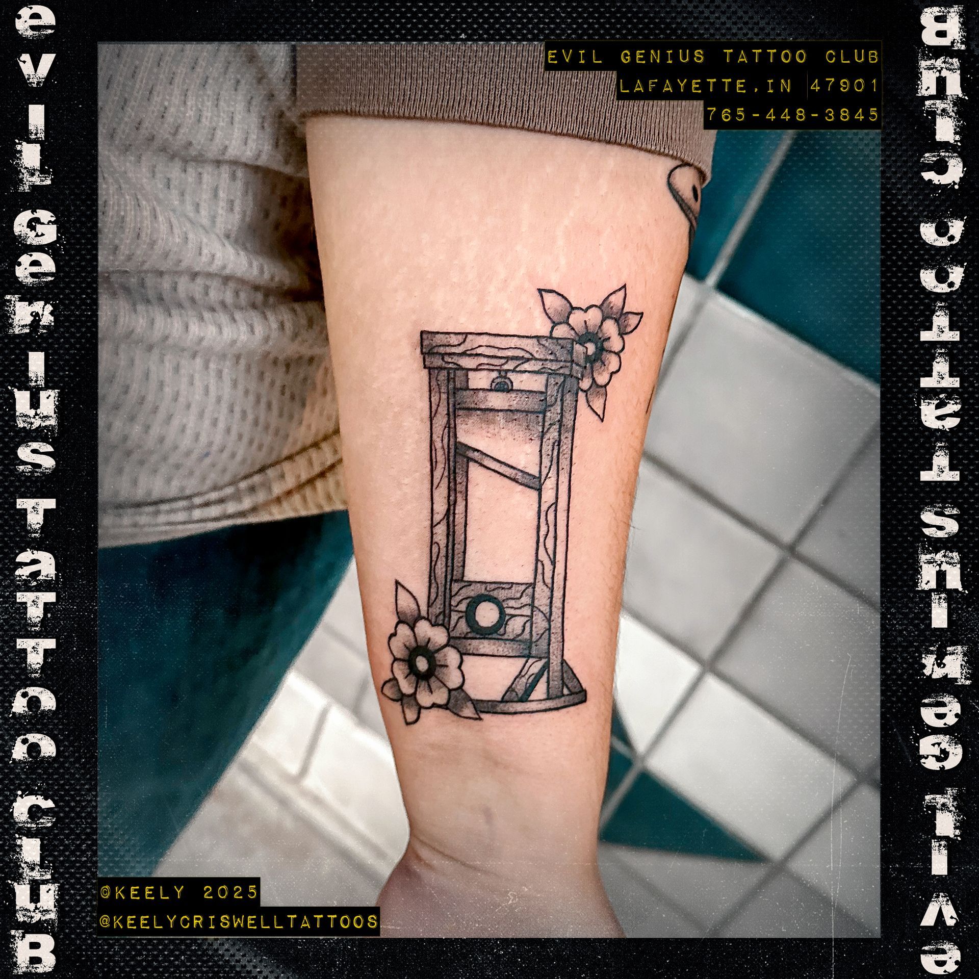 Tattoo of a guillotine with floral accents by Keely Criswell.