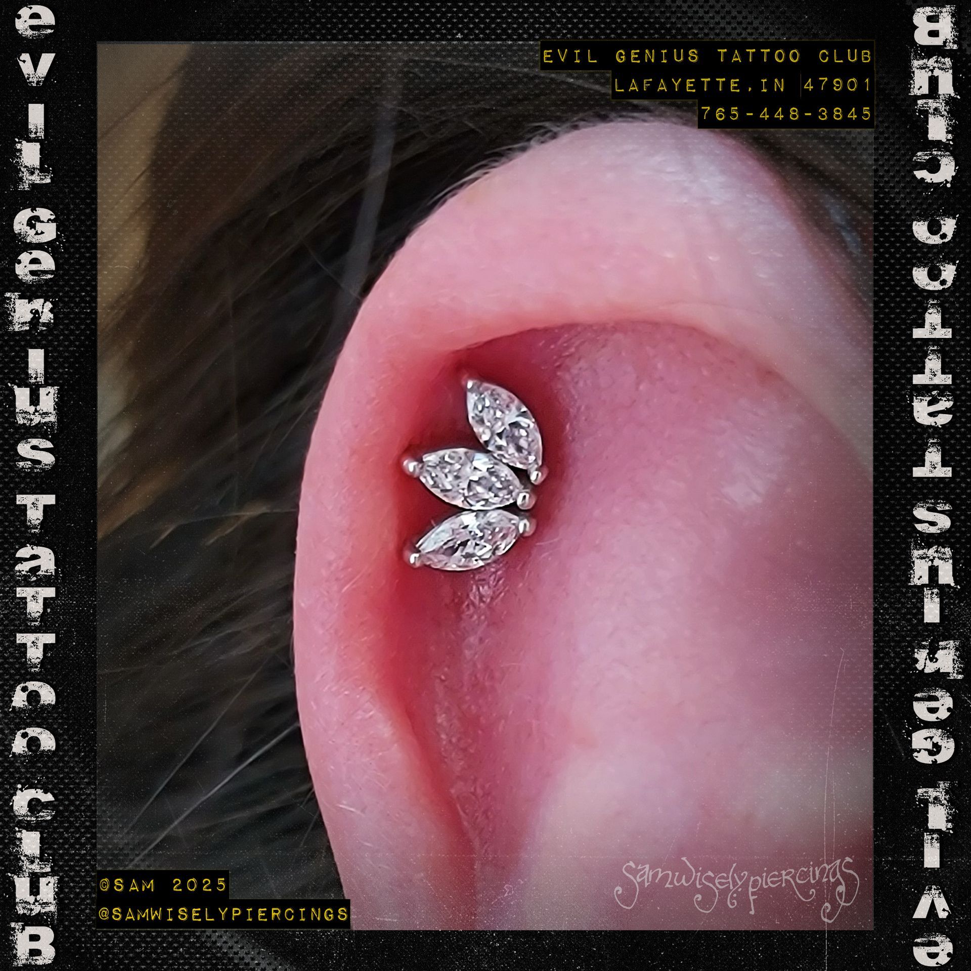 Close-up of an ear with a new helix piercing with jewelry featuring three marquise-shaped white gemstones performed by Sam. 