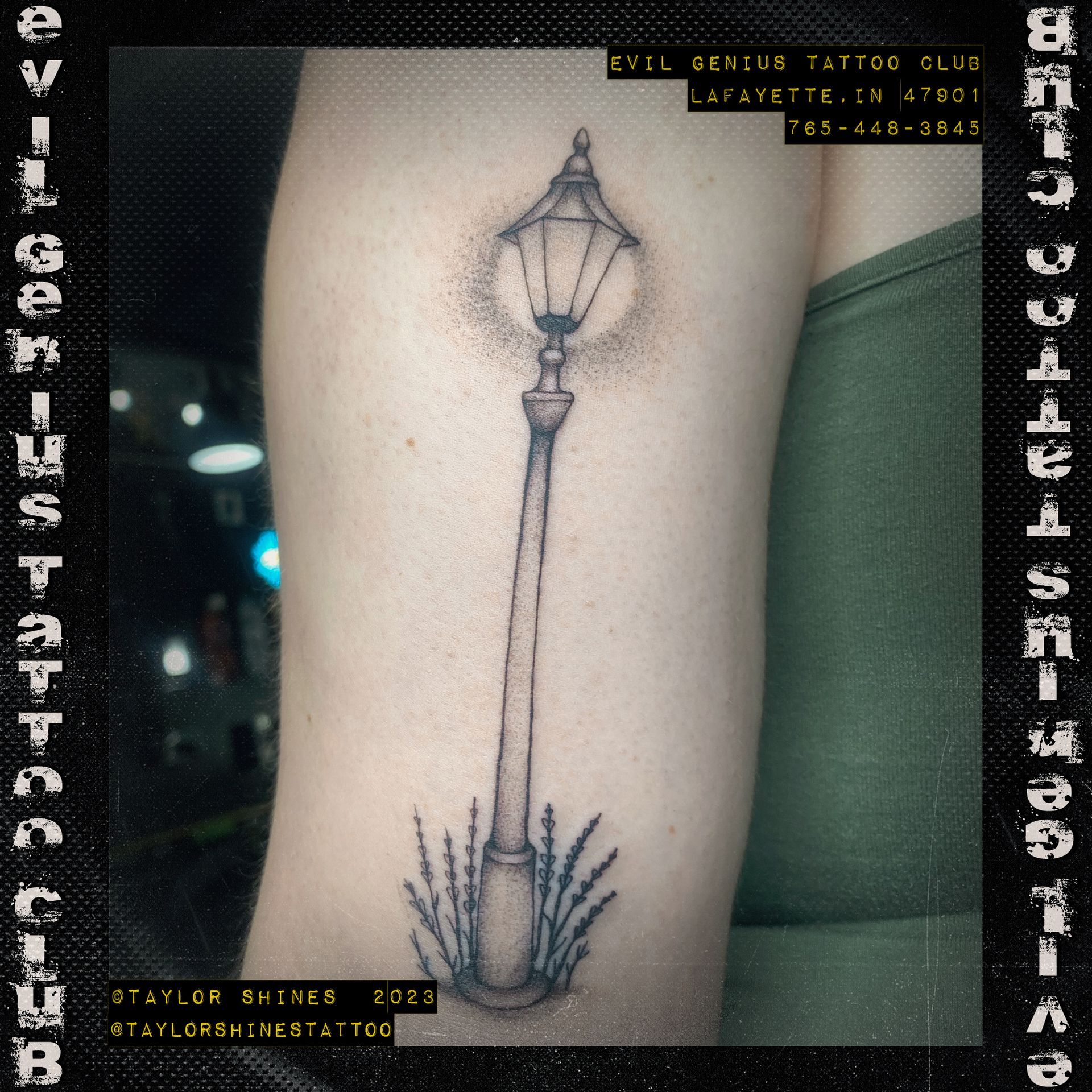 A tattoo of a lamp post on a person 's arm done by Taylor Shines.