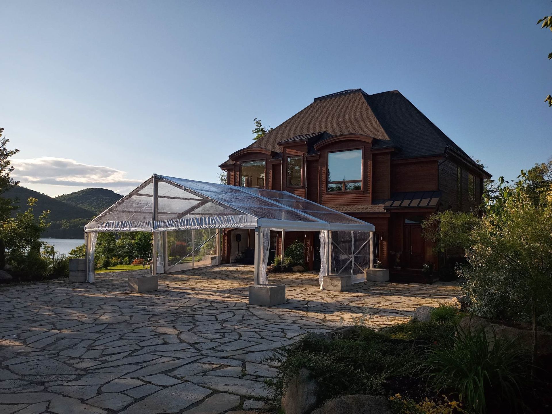 Une grande maison avec une tente claire devant