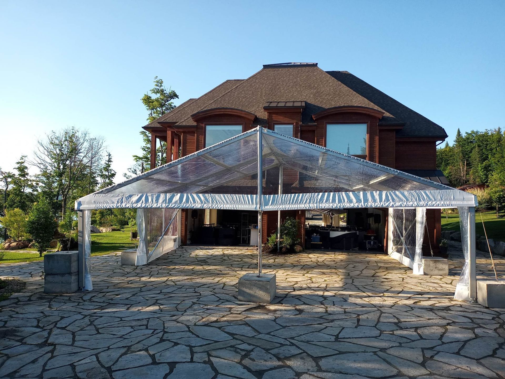 Une grande maison avec une tente claire devant