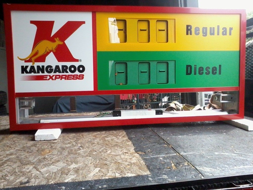 A man and a woman are looking at a painting on a table.