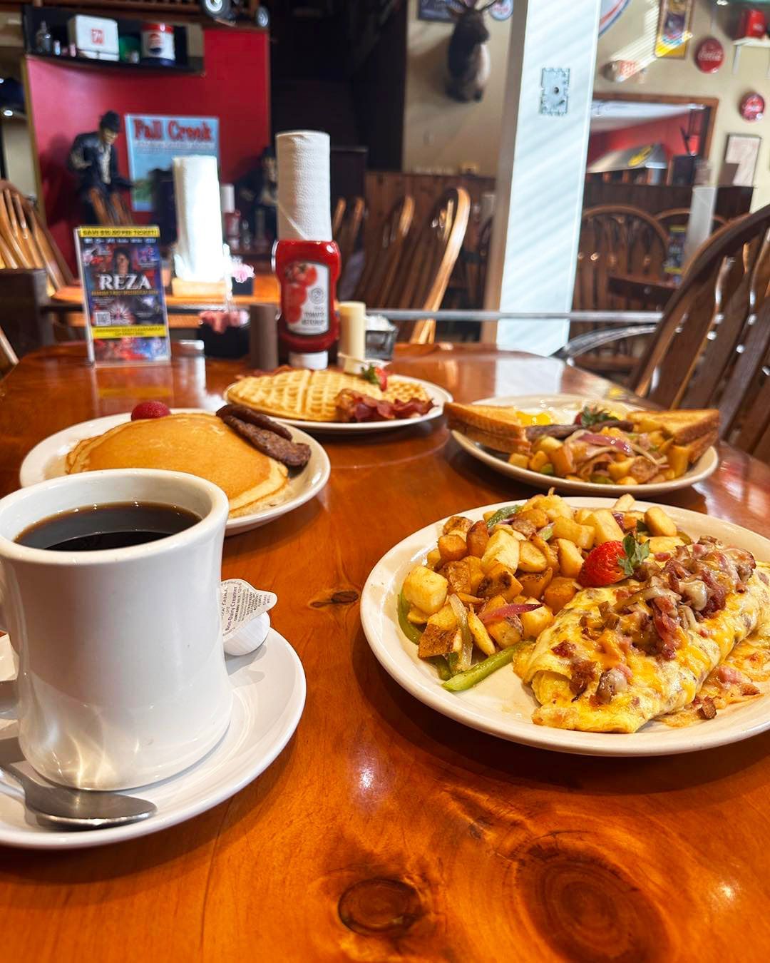 A table with plates of food and a cup of coffee