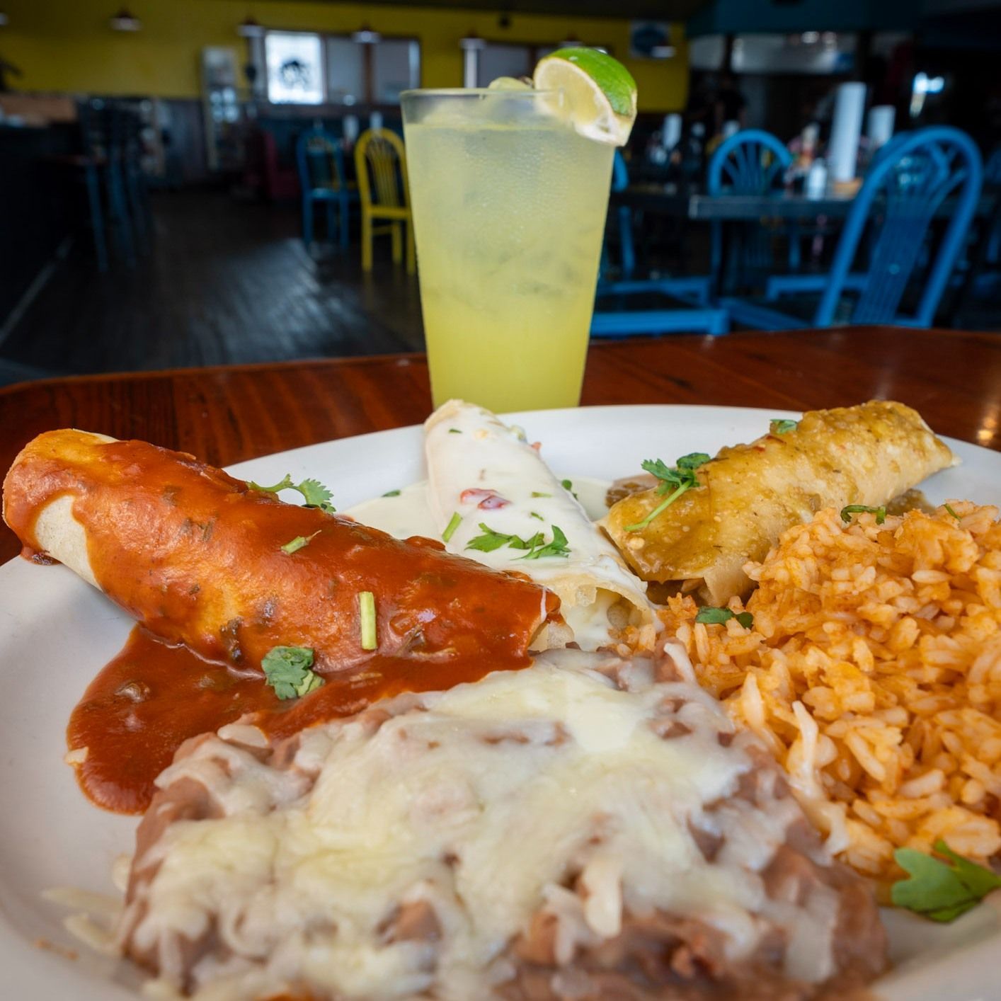 A plate of food with a drink in the background