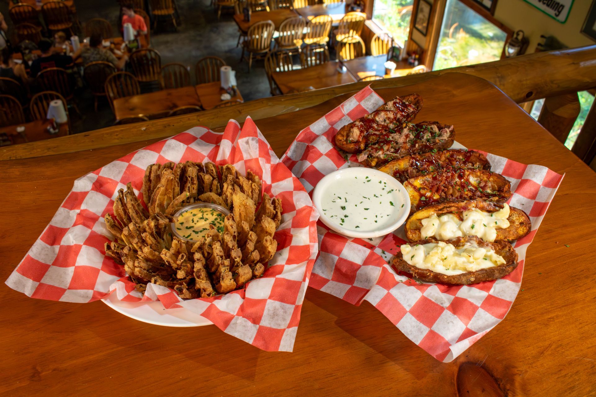 Two baskets of food are sitting on a wooden table.
