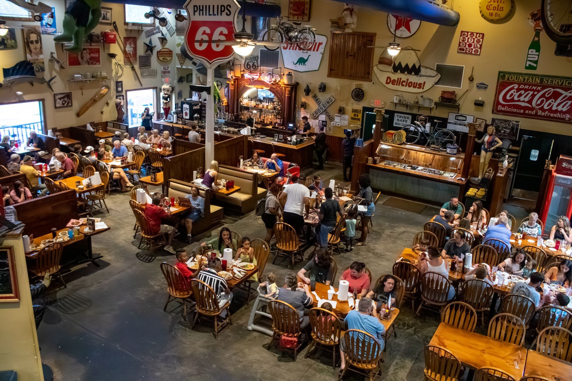 A large dining room filled with people sitting at tables and chairs.