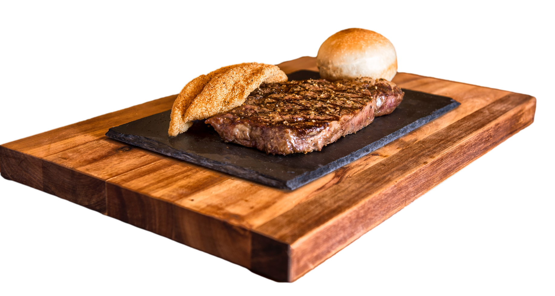 A steak and bread are on a wooden cutting board.