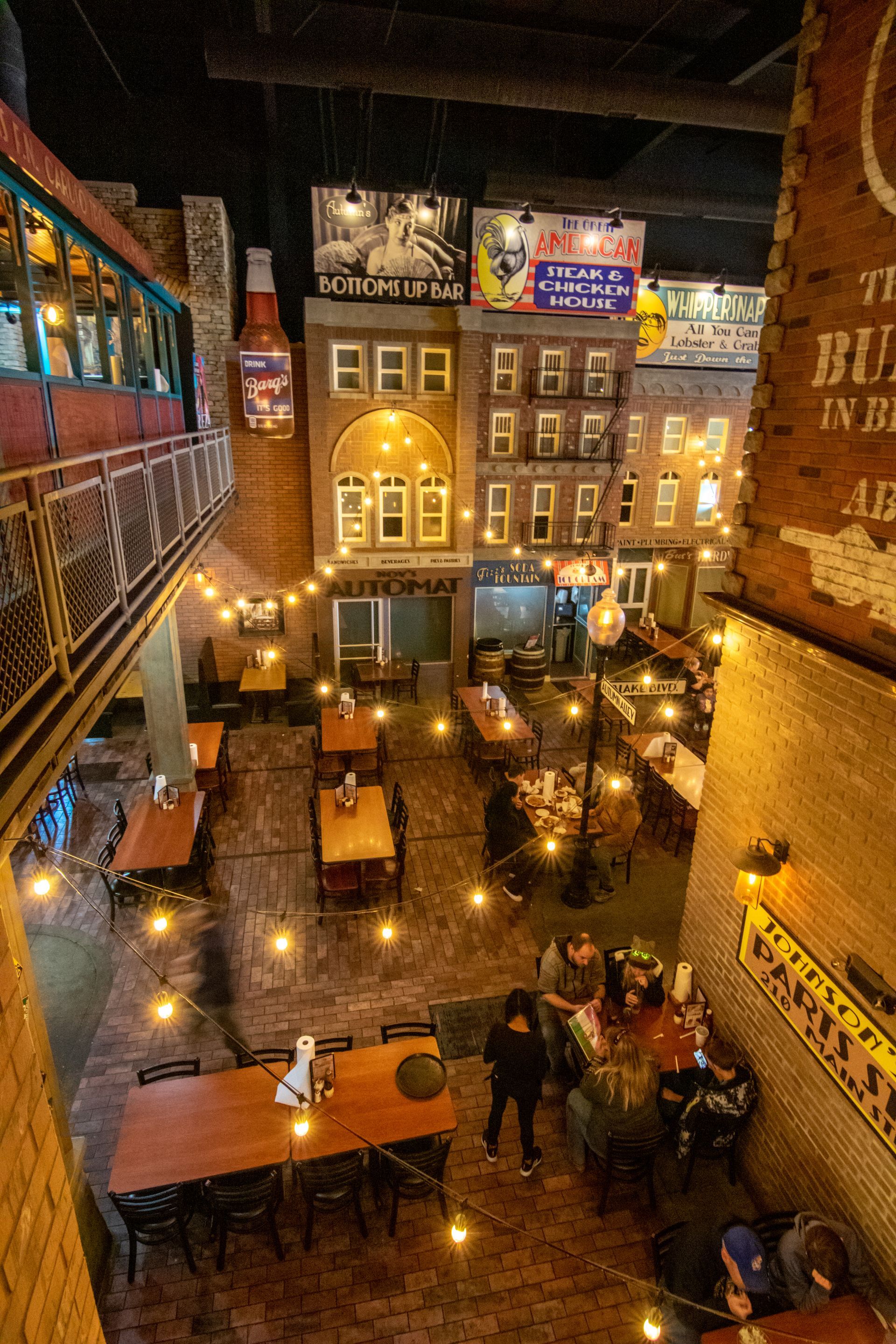 An aerial view of a restaurant filled with tables and chairs.