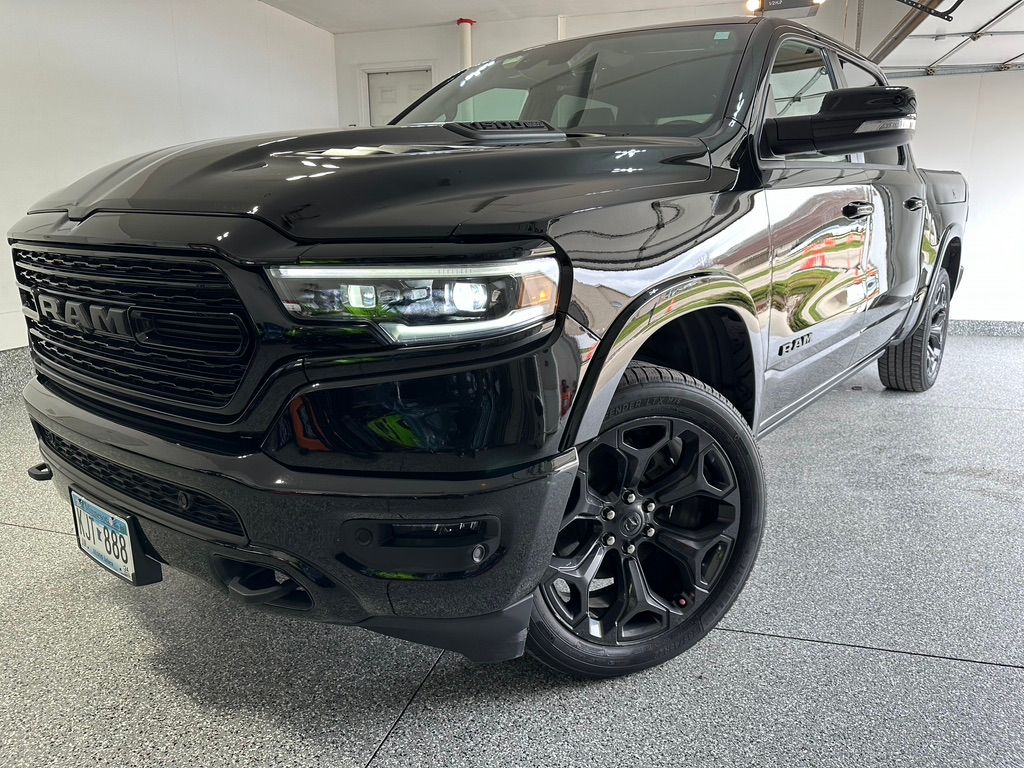 Black RAM pickup truck, front view, parked in a garage.