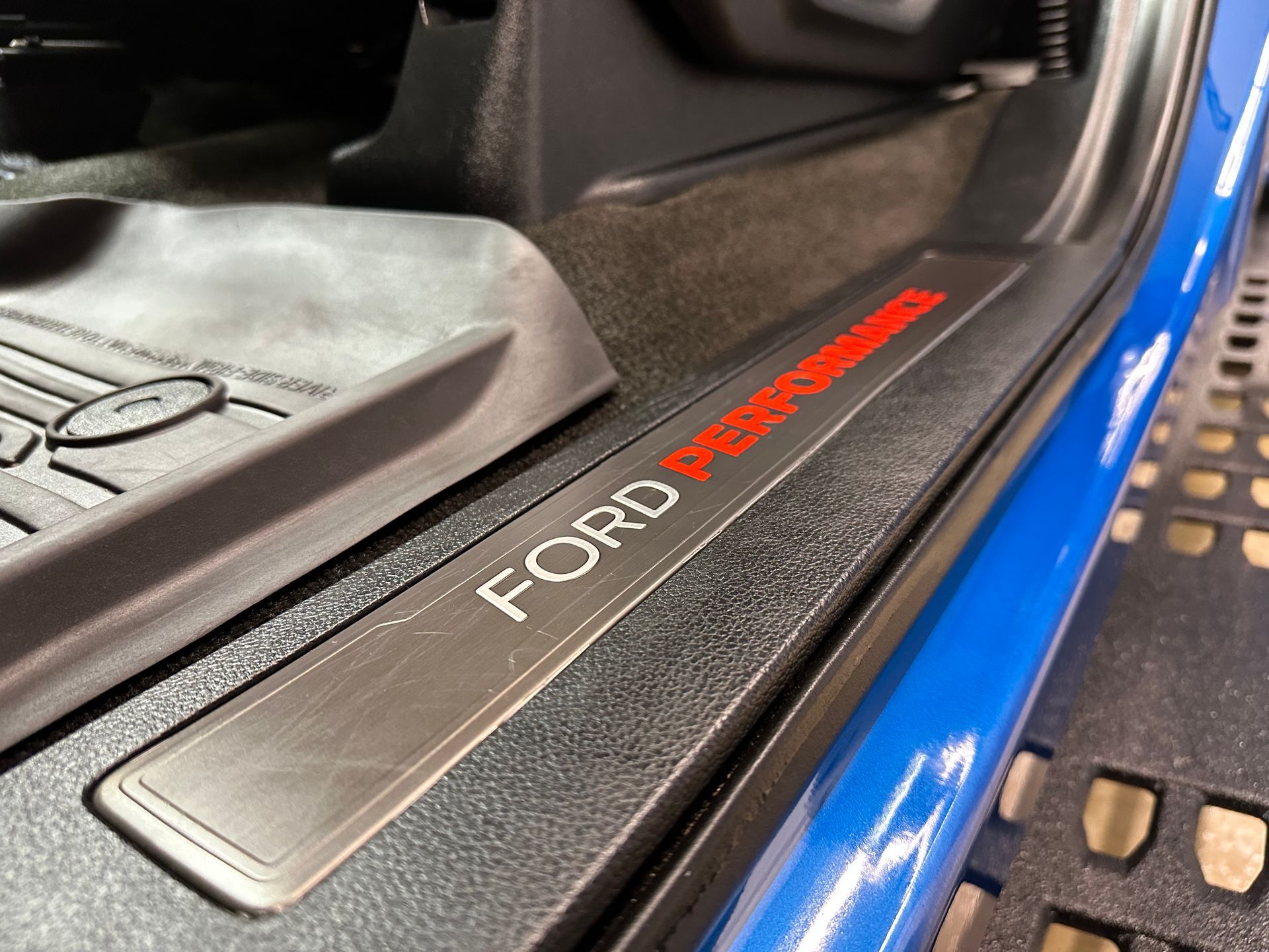Ford Performance door sill in a blue car interior.