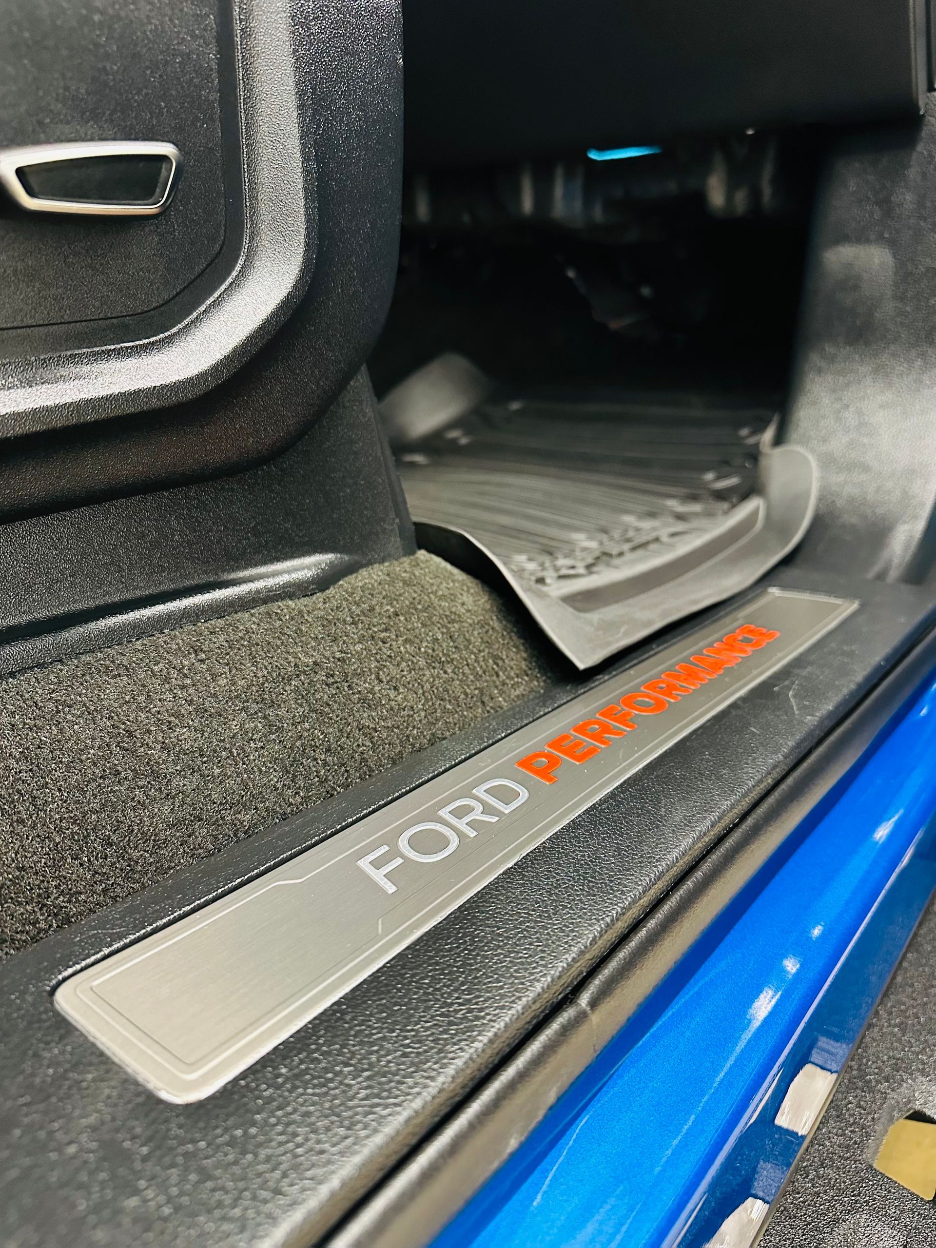 Ford Performance door sill in a blue car.